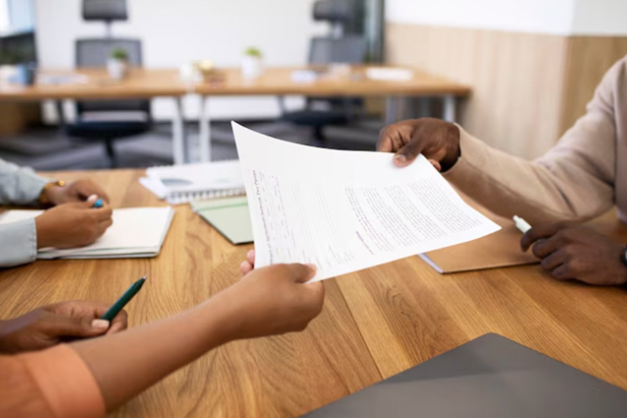 A person handing over a document