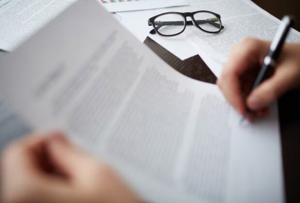 A person writing on a piece of paper