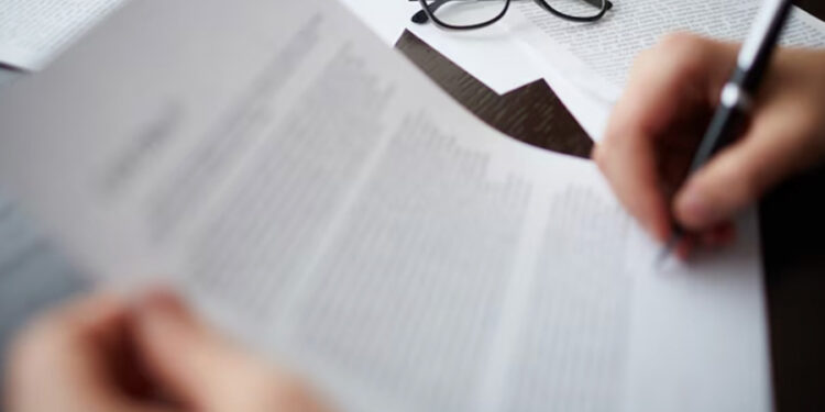 A person writing on a piece of paper